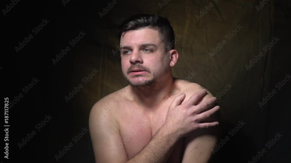 A bearded man shows that he is cold A bearded man shows that he is cold