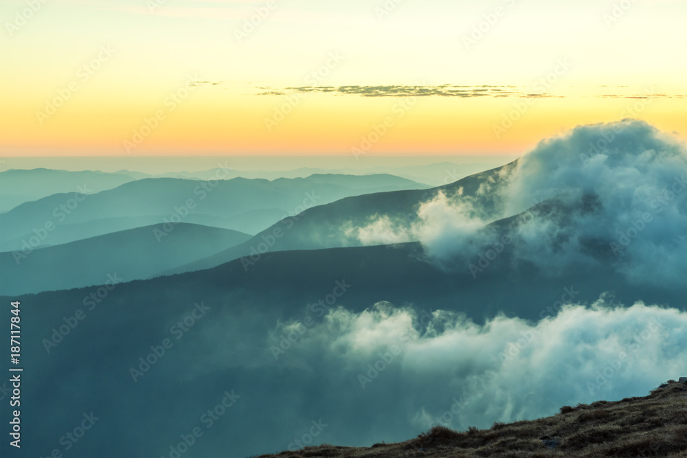 Iconic mountains view at morning against sunlight with peaks clouds Iconic mountains view at morning against sunlight with peaks clouds