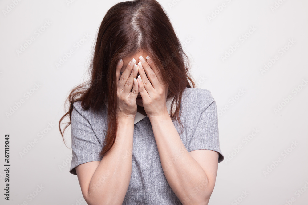 Sad young Asian woman cry with palm to face. Sad young Asian woman cry with palm to face.