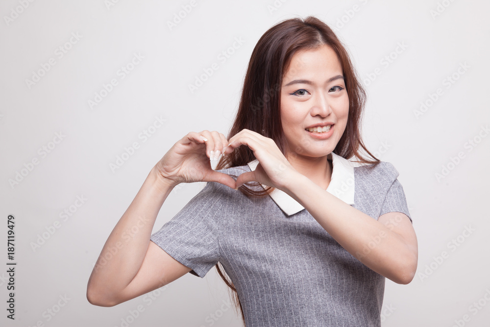 Young Asian woman show heart hand sign. Young Asian woman show heart hand sign.