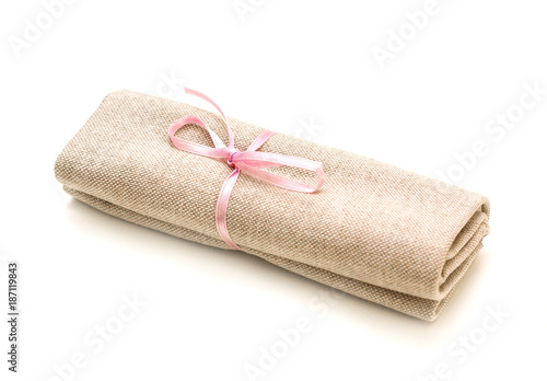 Cloth bundle, tied with a pink ribbon, isolated on white