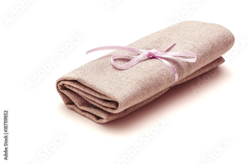 Cloth bundle, tied with a pink ribbon, isolated on white