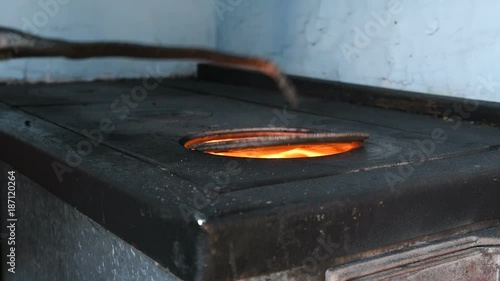 poured a bucket of coal into the furnace
