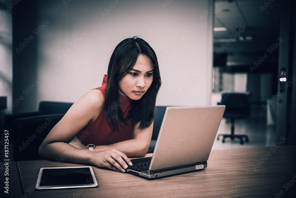 Business woman stress from hard work on the desk at office dark tone,Thailand people,Secretary sad from boss Business woman stress from hard work on the desk at office dark tone,Thailand people,Secretary sad from boss