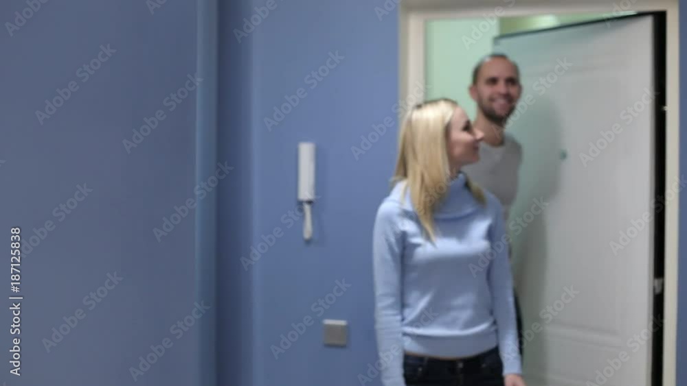 Happy family couple holding boxes opening door entering new luxury house Happy family couple holding boxes opening door entering new luxury house