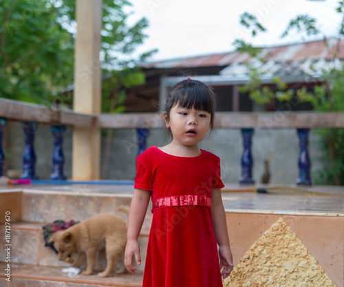 The girl playing with the dog photo