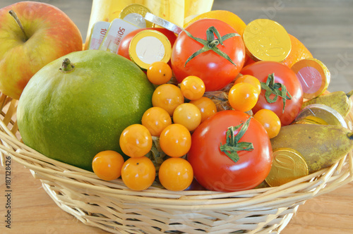 a fruits are the treasures of nature. fruits and chocolate coins in the basket 