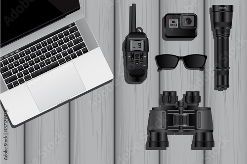 The equipment of a spy or private detective: laptop, walkie-talkie, action camera, flashlight, sunglasses and binoculars. Vector illustration EPS 10