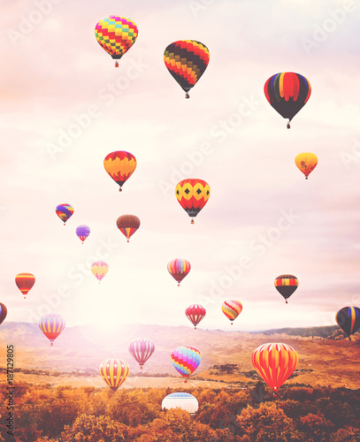 hot air balloons in the sky during sunrise toned with a retro vintage instagram filter app or action effect