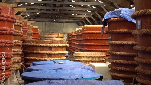 Big barrels of fish sauce Wooden barrels in a fish sauce factory on Phu Quoc island. Fish sauce. Vietnam. photo