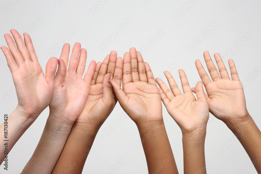 many raised hands in a row