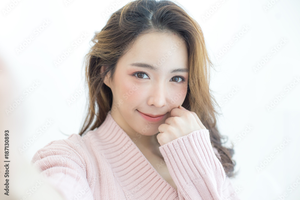 Attractive Asian Woman using smartphone for selfie with happy emotion, People lifestyle concept. Attractive Asian Woman using smartphone for selfie with happy emotion, People lifestyle concept.