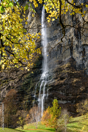 Beautiful autumn time at village of Lauterbrunnen in Swiss alps  gateway to famous Jungfrau. Set in a valley featuring rocky cliffs and the roaring  300m-  high Staubbach Falls