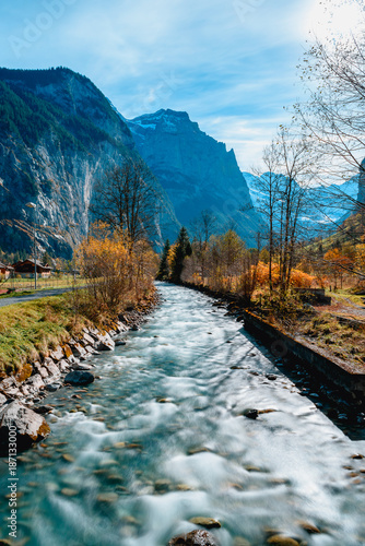 Beautiful autumn time at village of Lauterbrunnen in Swiss alps, gateway to famous Jungfrau. Set in a valley featuring rocky cliffs and the roaring, 300m-­high Staubbach Falls