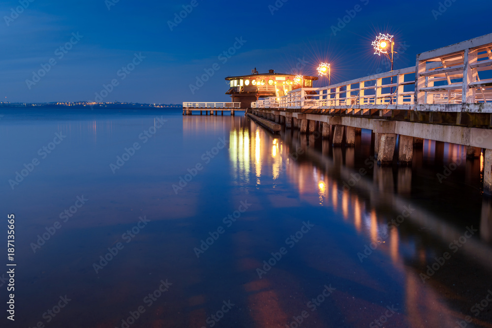 Illuminated pier in Puck at night. Baltic Sea, Poland.