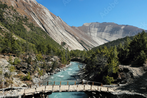 Bridge in mountain valley in nepalese himalayas
