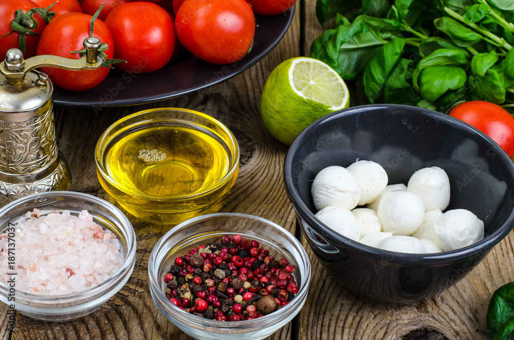 Mozzarella, basil, tomatoes, olive oil-ingredients for caprese