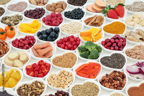 Health food for a healthy heart concept with vegetables, fruit, fish, nuts, seeds, supplement powders, pulses, cereals and herbs used in herbal medicine. High in omega 3, fibre & antioxidants.