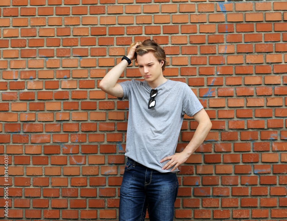 Attractive teenage boy in urban background Attractive teenage boy in urban background