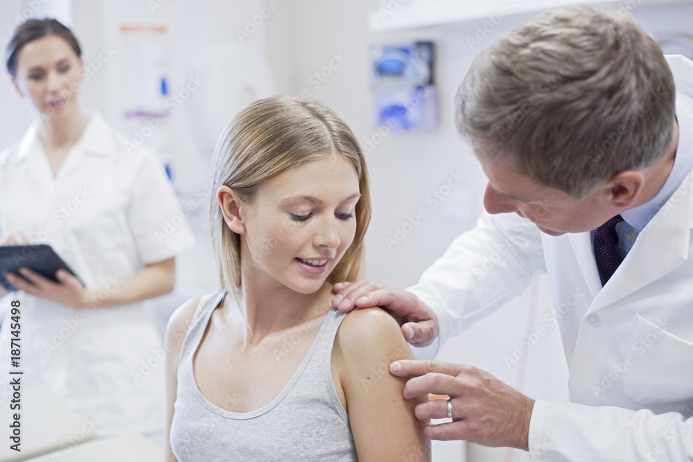 Male doctor examining the patient in the hospital Male doctor examining the patient in the hospital