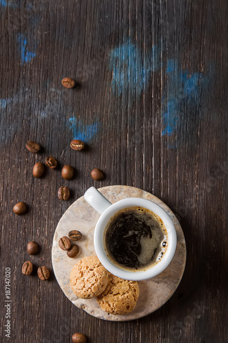Italian homemade espresso coffee in a white mug. Dark background.