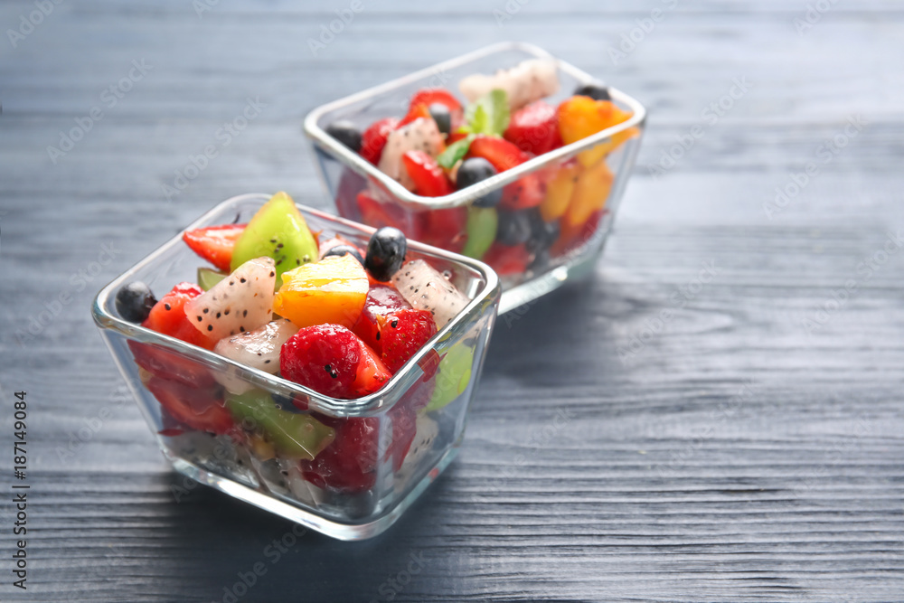 Dessert bowls with delicious fruit salad on wooden table Dessert bowls with delicious fruit salad on wooden table