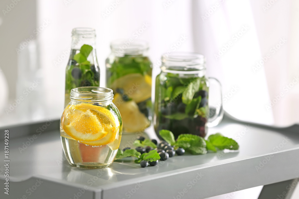 Glassware of infused water with fruits and berries on table Glassware of infused water with fruits and berries on table