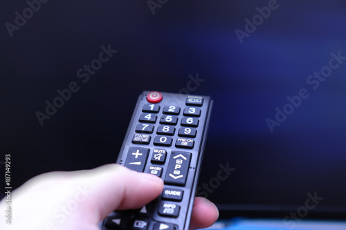 Remot Control Pointing at Blue TV Screen photo