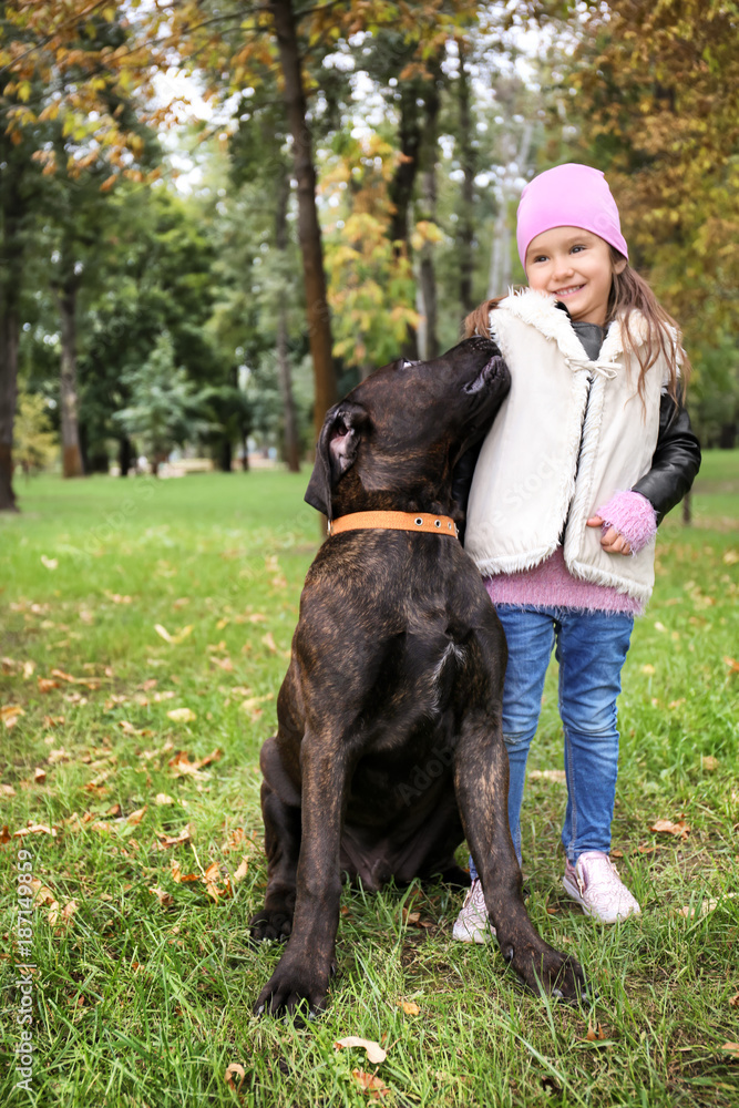 Cute little girl with her dog in autumn park Cute little girl with her dog in autumn park