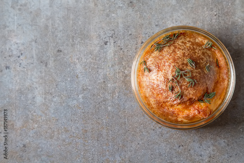 French baked cheese souffle close-up on a table. Dark background.