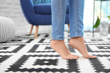 Woman standing on carpet at home