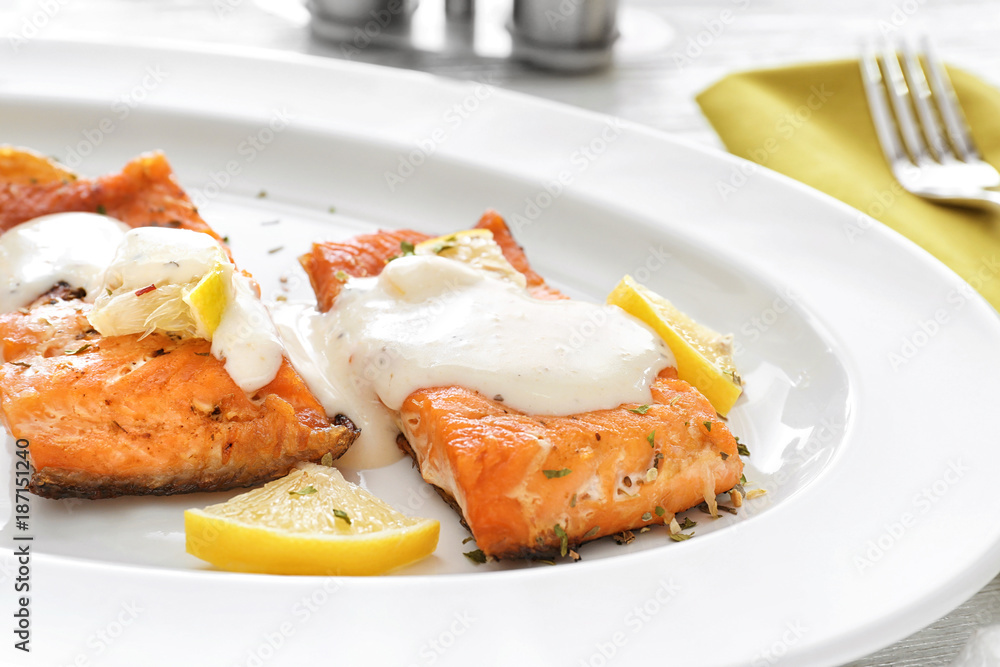 Tasty rainbow trout fillets with sauce on plate, closeup Tasty rainbow trout fillets with sauce on plate, closeup