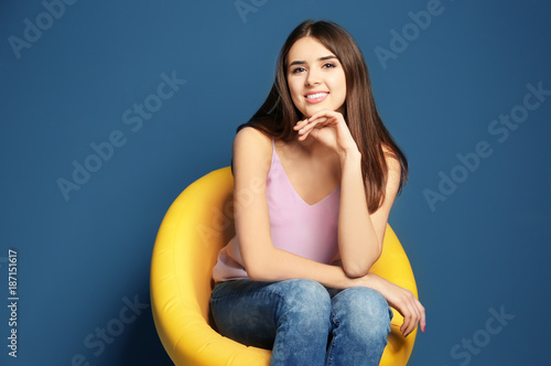 Smiling young woman sitting...