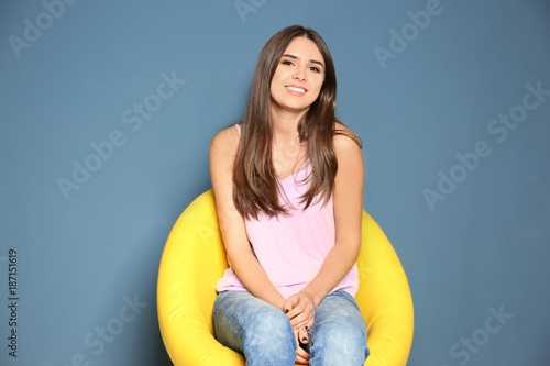 Smiling young woman sitting...