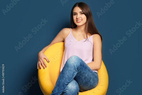 Smiling young woman sitting...