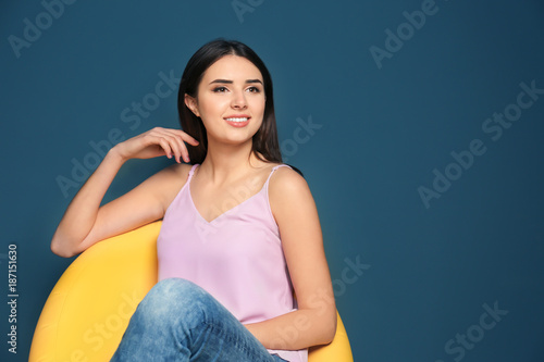 Smiling young woman sitting...