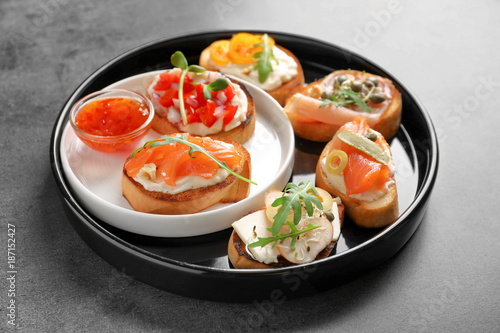 Plate with tasty fresh bruschettas on table