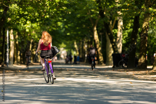A girl biking in the Amsterdam Vondelpark.