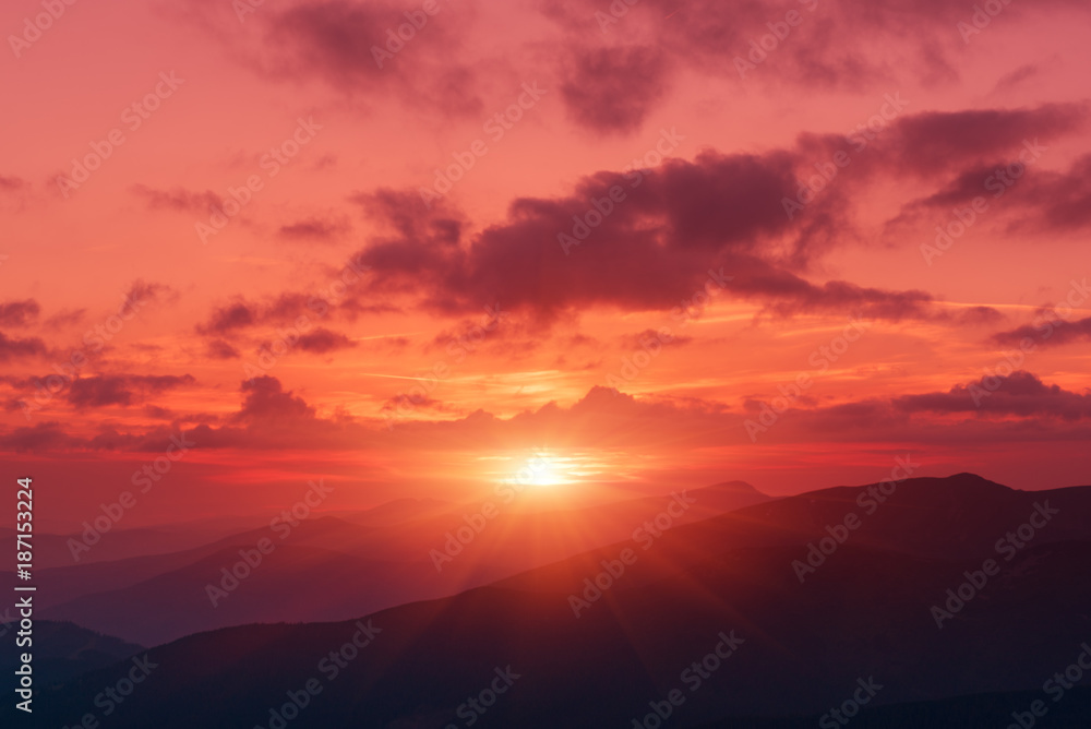 Amazing mountain landscape with colorful vivid sunset on the bright sky, natural outdoor travel background