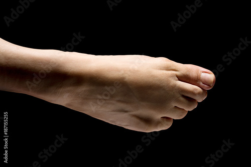 Ballerina's foot close up isolated on black background