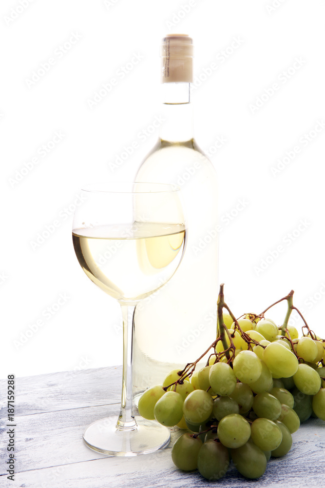 Glass of wine and grapes on wooden background. white wine concept