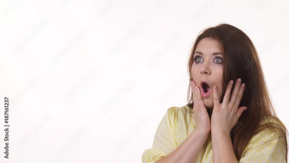 Shocked and surprised woman pointing with finger at copy space, giving thumb up. Advertisement concept. 4K ProRes HQ codec Shocked and surprised woman pointing with finger at copy space, giving thumb up. Advertisement concept. 4K ProRes HQ codec
