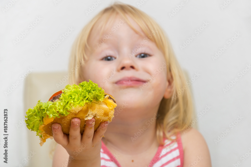 Happy hungry girl eating healthy vegan burger. Happy hungry girl eating healthy vegan burger.