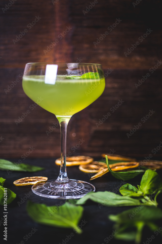 Green cocktail on the background of a wooden background. Green cocktail on the background of a wooden background.