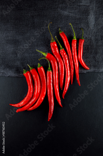 red hot chilli peppers decorated on slate plate kitchen table can be used as background