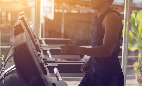 Electric treadmills,People running in machine treadmill at fitness gym,asian man exercising ,health care sport concept,selective focus,vintage color,in the morning