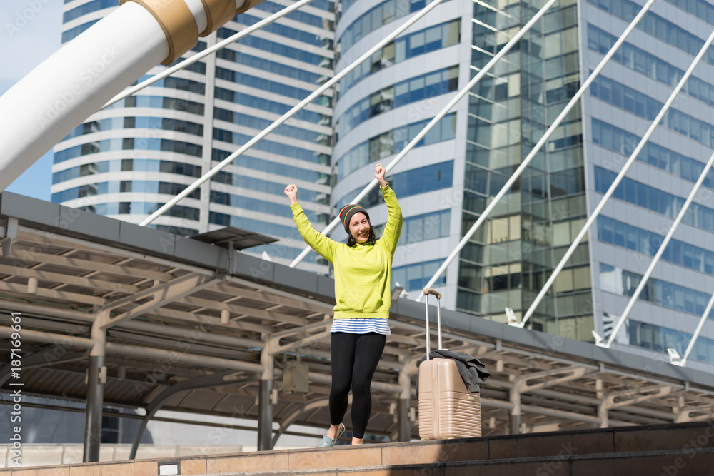 Excited Russian beautiful woman jump raising her arms with luggage travel journey ideas concept. Happy glad woman tourist, vacation holidays, winter traveler Excited Russian beautiful woman jump raising her arms with luggage travel journey ideas concept. Happy glad woman tourist, vacation holidays, winter traveler