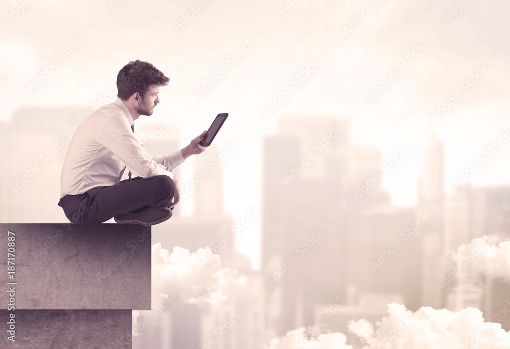 Peaceful sales guy sitting on roof top