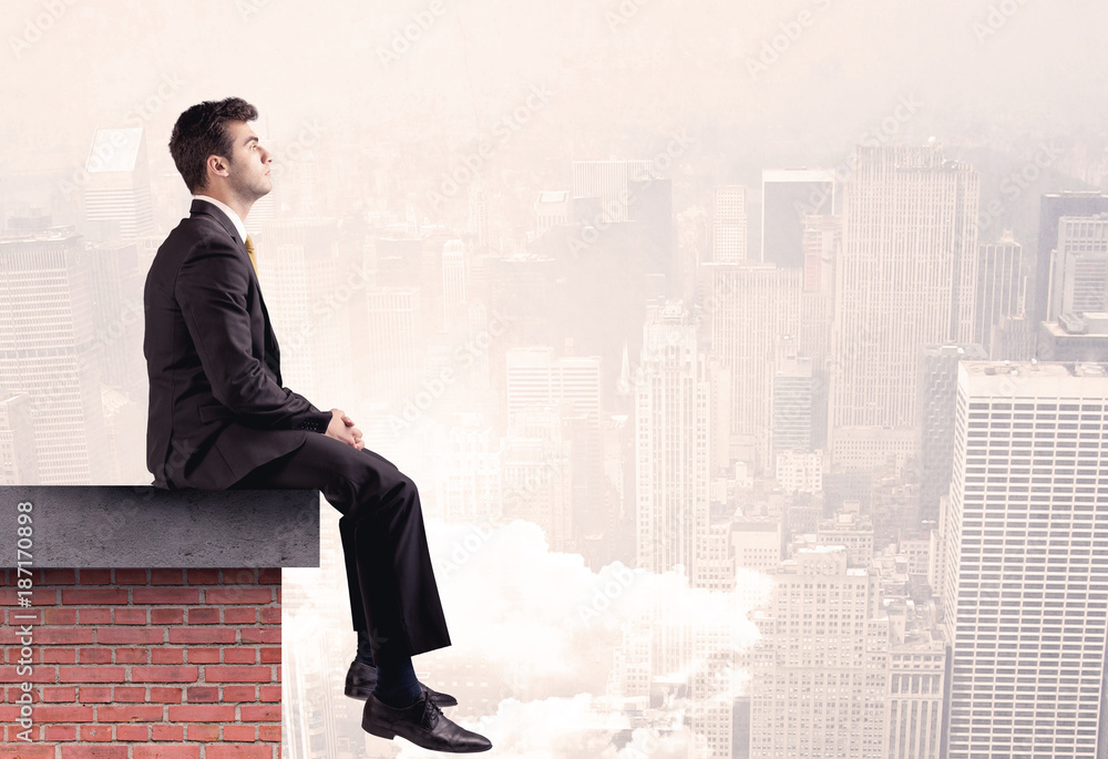 Office worker sitting on rooftop in city