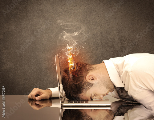 Sad business person's head catching fire